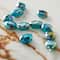 12 Packs: 11 ct. (132 total) Aqua Faceted Glass Oval Beads, 15.5mm by Bead Landing™